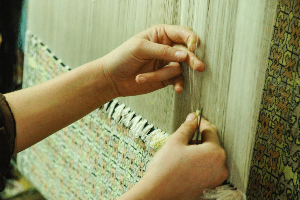Hands woving a rug