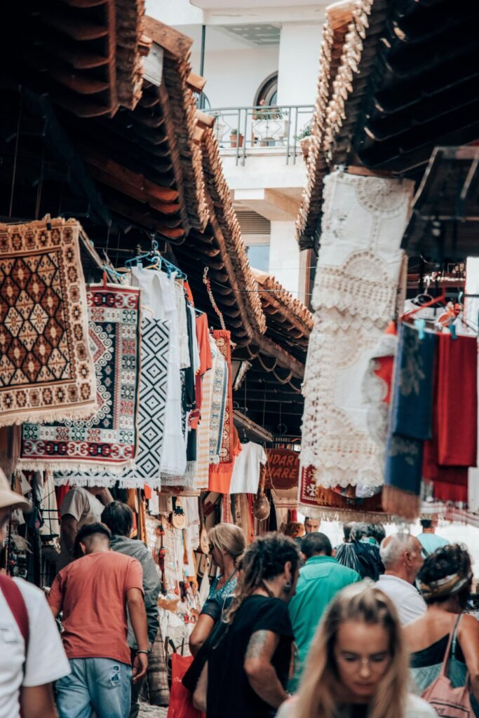 Travelers exploring a bustling artisan market filled with handmade textiles and cultural crafts during a Goods Getaways travel experience.